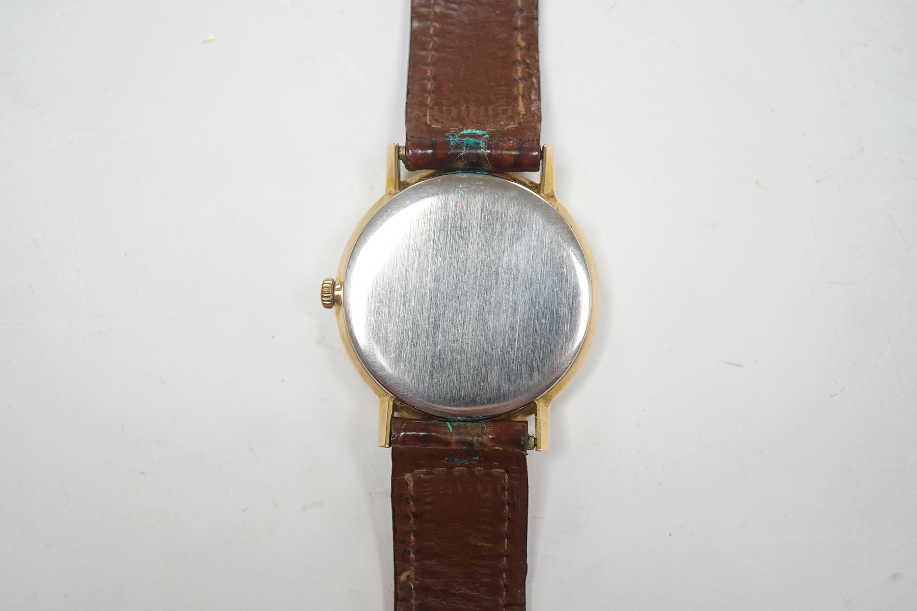 A gentleman's gold plated Omega manual wind wrist watch, on a leather strap, case diameter 34mm. Condition - Fair